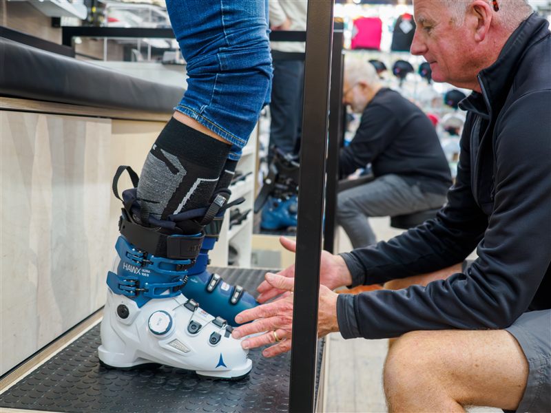 Boot fitter assessing ski boot fit on customer at Captain's Cabin